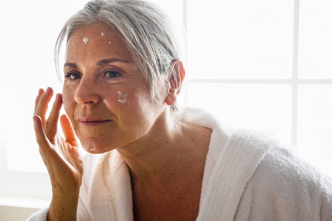 Applying anti-aging cream to moisturize and nourish facial skin
